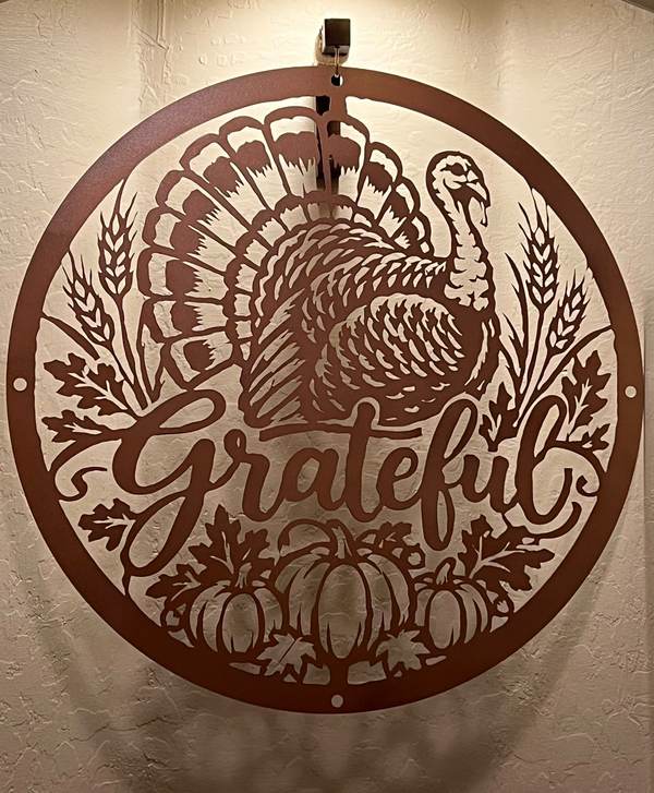 Dining room wall, brushed copper turkey sculpture, reclaimed wood sideboard, soft pendant lighting, cream walls.