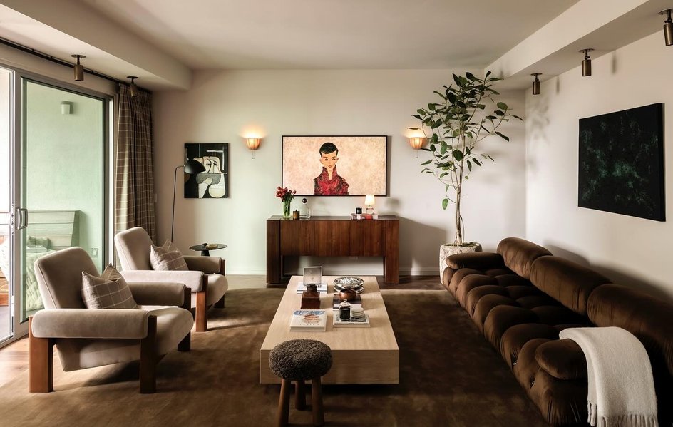 Teak furniture with coral accent chair and midcentury modern decor