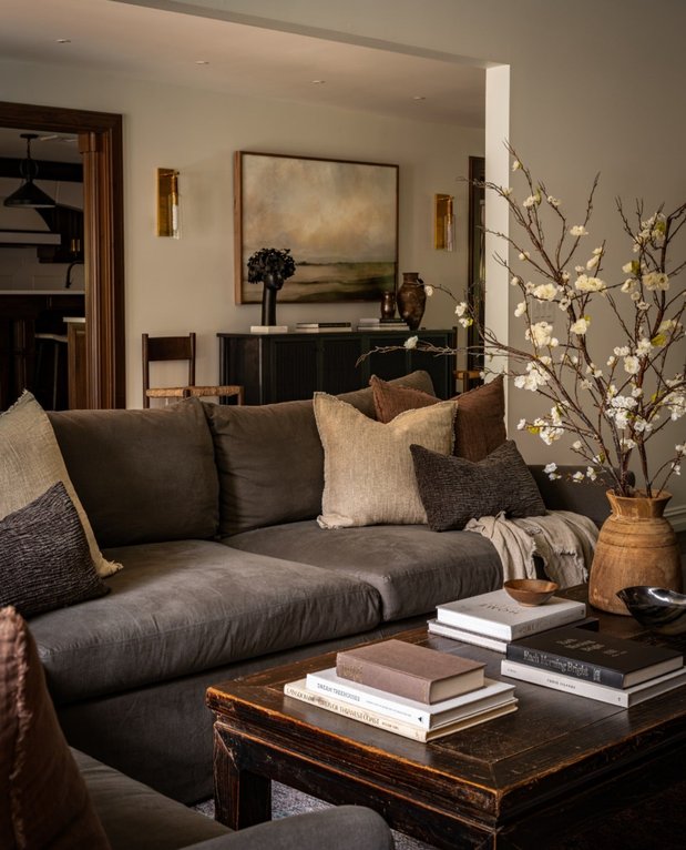 Dark espresso walls with mushroom lamp and leather sofa for moody vibe