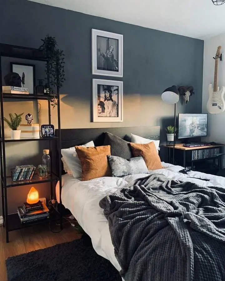 Bedroom with deep moody blue walls, layered textile textures, and soft ambient lighting.