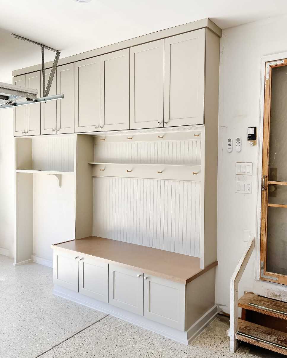 Mudroom adjacent to garage, metal utility rack, rugged rubber mat, industrial pendant lighting
