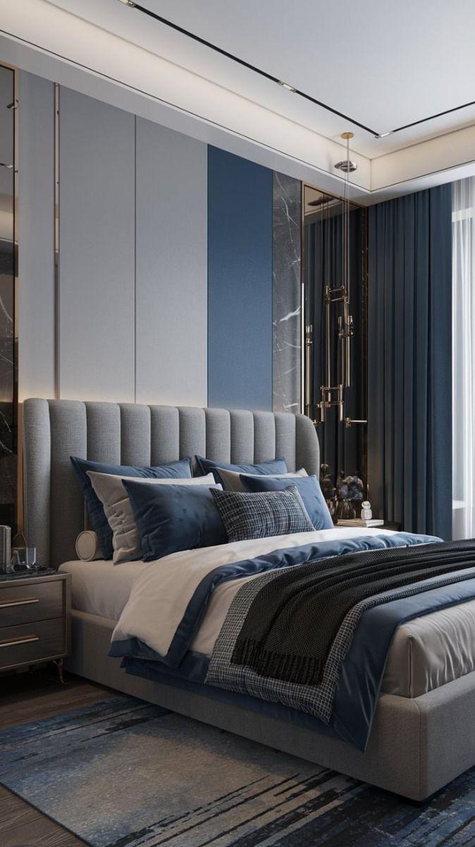 Navy bedroom featuring a channel headboard, marble side panels, and subtle lighting.