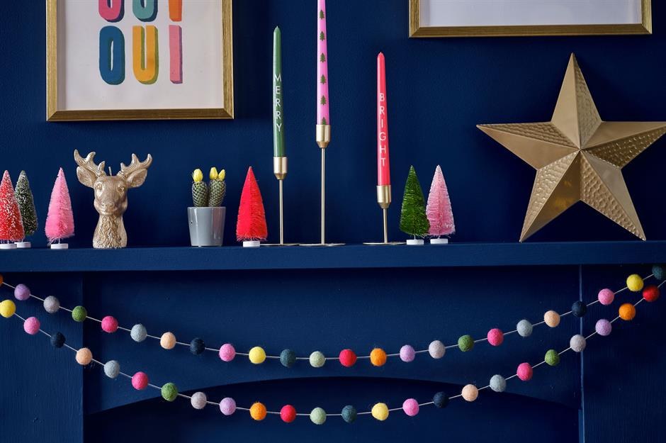 Living room mantel, navy fabric garland, miniature trees, warm incandescent bulbs
