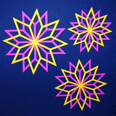 Modern loft, concrete floor, neon pink and yellow star cutouts, cool LED lighting