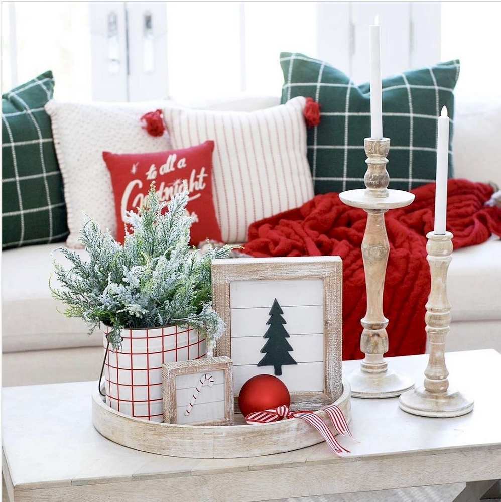 Cozy neutral Christmas coffee table decor styled with beige pillar candles and subtle beige ribbon.