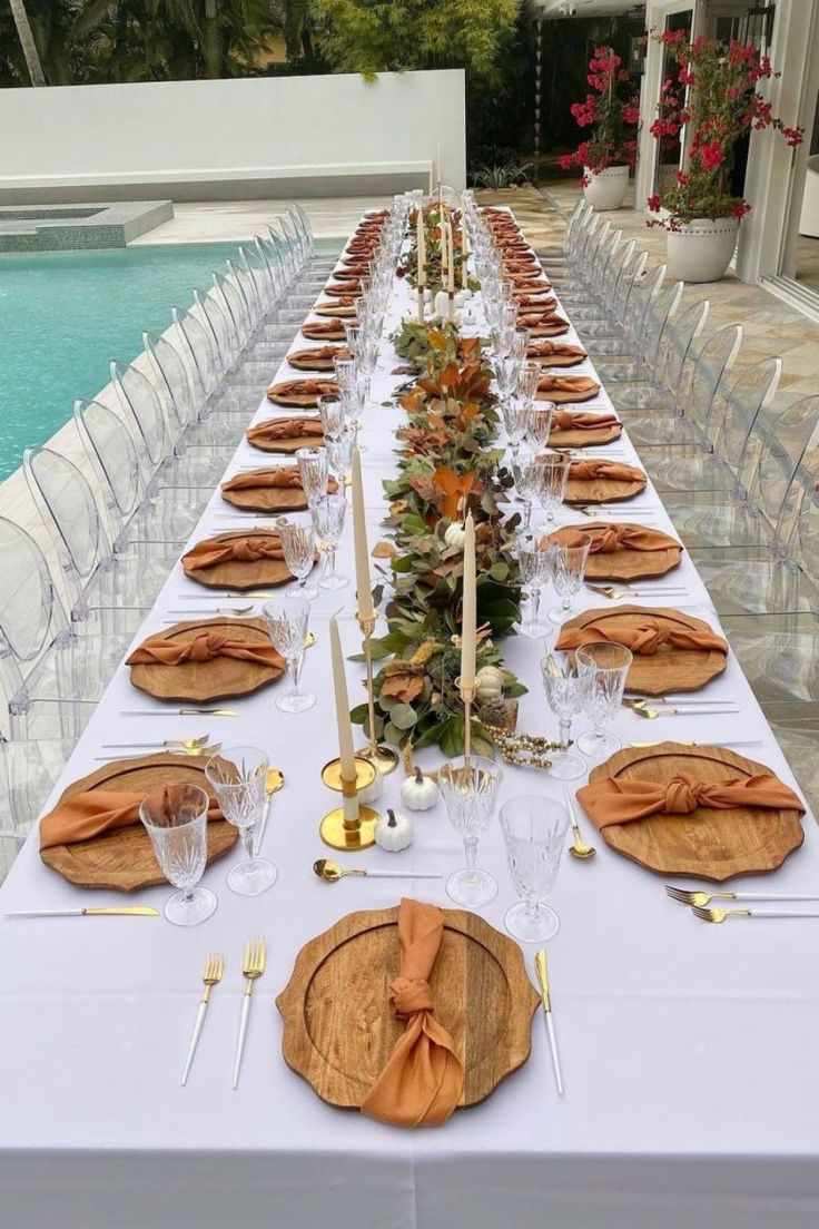 Poolside table with teal linens, turquoise glassware, floating candles, soft sunset lighting, relaxed vibe