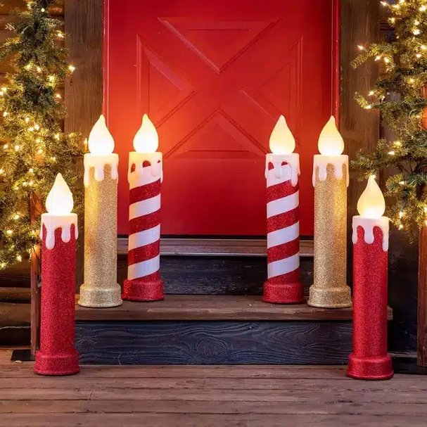 Bluestone porch steps decorated with red and gold metal lanterns containing glowing LED candles.