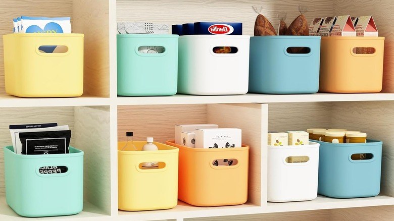 Pantry organization ideas featuring glass jars with chalkboard labels on rustic wooden shelves.