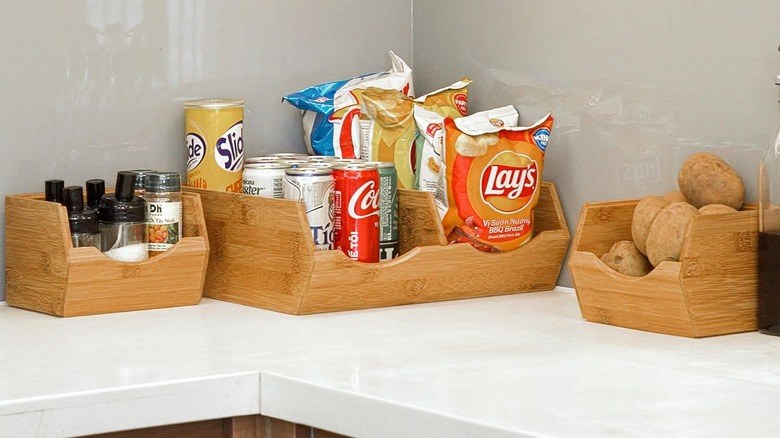 Pantry organization ideas featuring eco-friendly bamboo bins organized inside wide kitchen drawers.