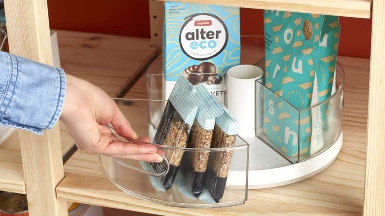 Pantry organization ideas using industrial wire mesh bins with stylish metal handle tags.