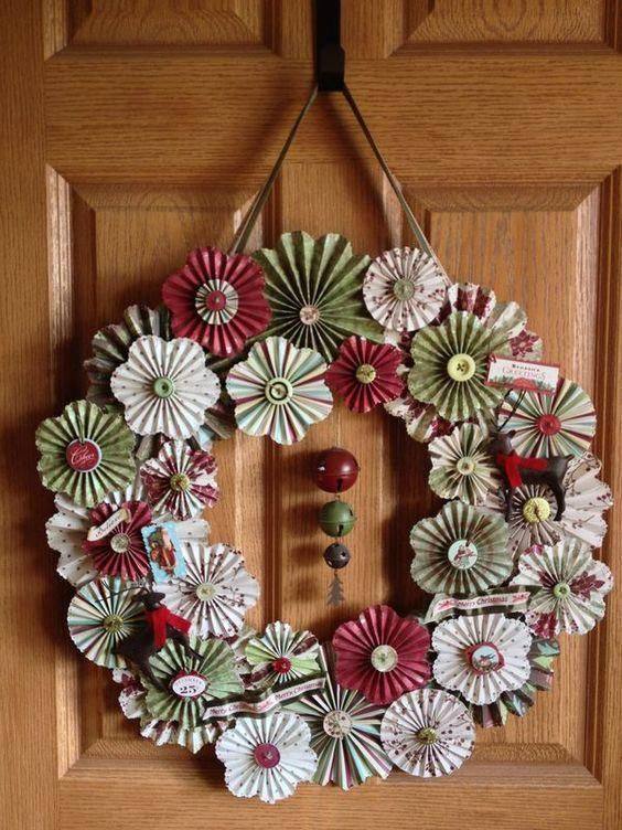 Colorful paper pinwheel wreath made from festive patterned cardstock for a playful holiday vibe.
