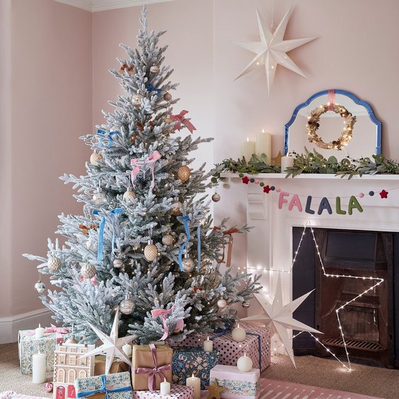 Sunlit living room frosted tree with pastel pink and baby blue ribbons, modern white furniture