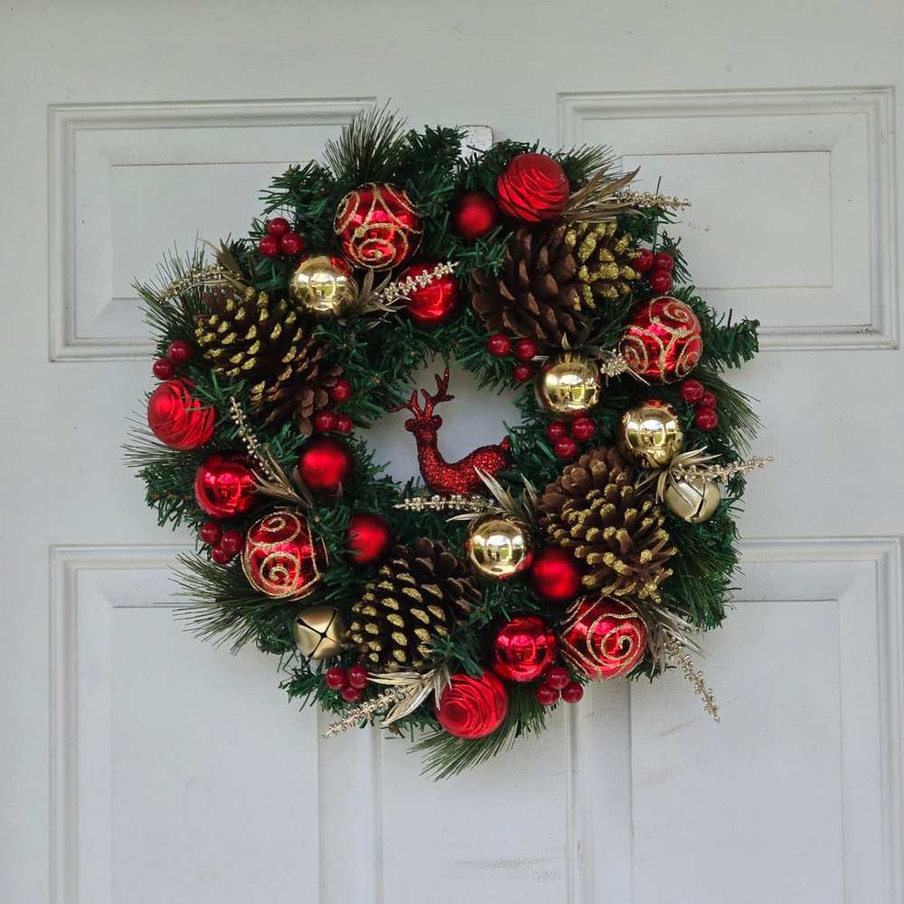 Rustic pinecone wreath with metallic gold accents for a luxurious woodland holiday aesthetic.