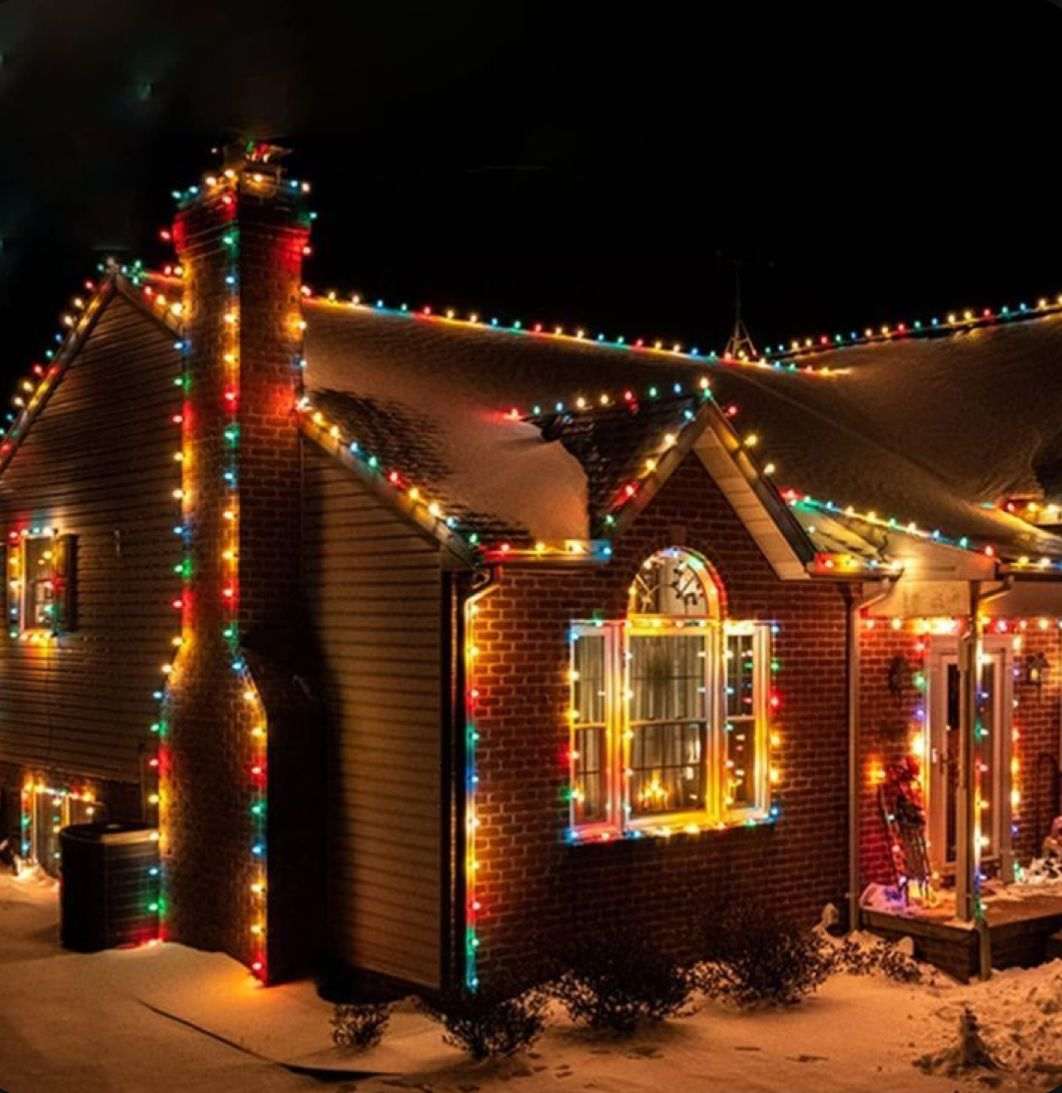 Christmas tree lights wrapped only around outer branch tips leaving dark hollow interior tree spaces.