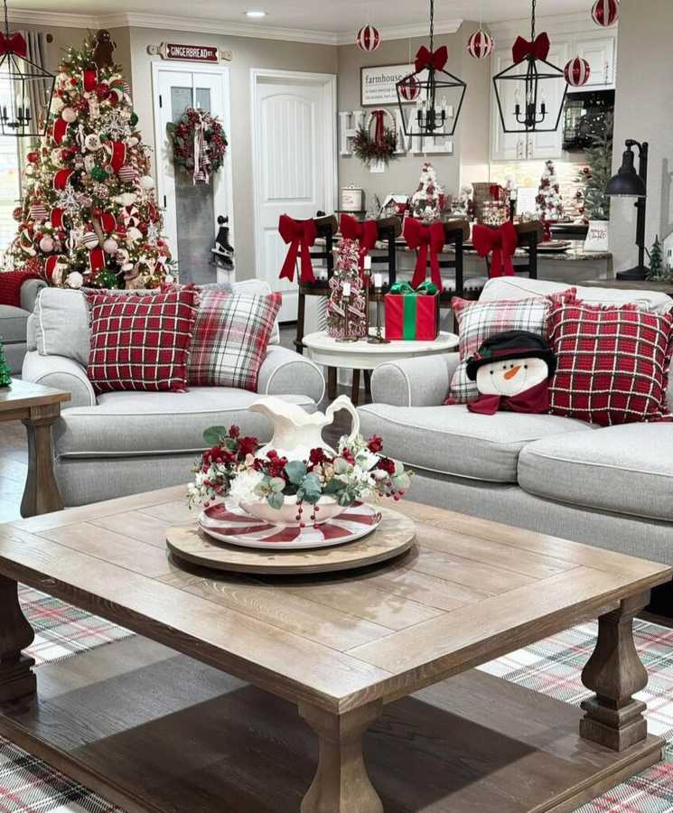 Playful holiday coffee table decor featuring tartan plaid ribbon, candy canes, and evergreen sprigs.