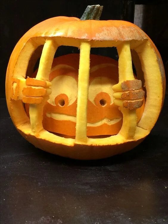 A pumpkin carved with a repeating geometric fan pattern in an art deco style.