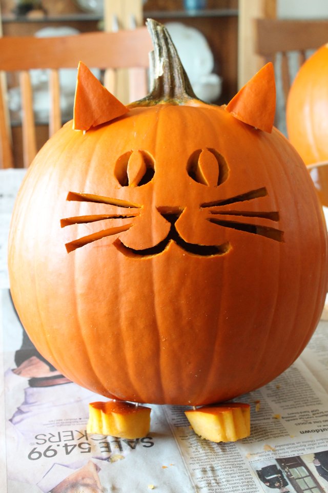 A dark painted pumpkin with drilled constellation points and etched lines.