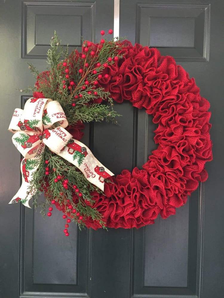 Textured red burlap wreath with a rustic aesthetic and a large central bow.