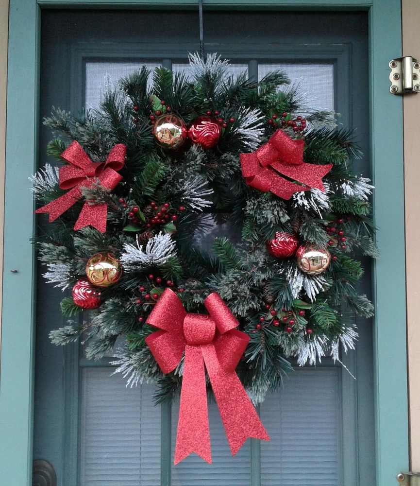 Luxurious red and gold ornament wreath featuring a variety of shiny and matte baubles.
