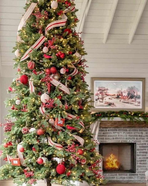 Modern farmhouse lounge featuring red striped ribbon tree near leather armchair in morning sun