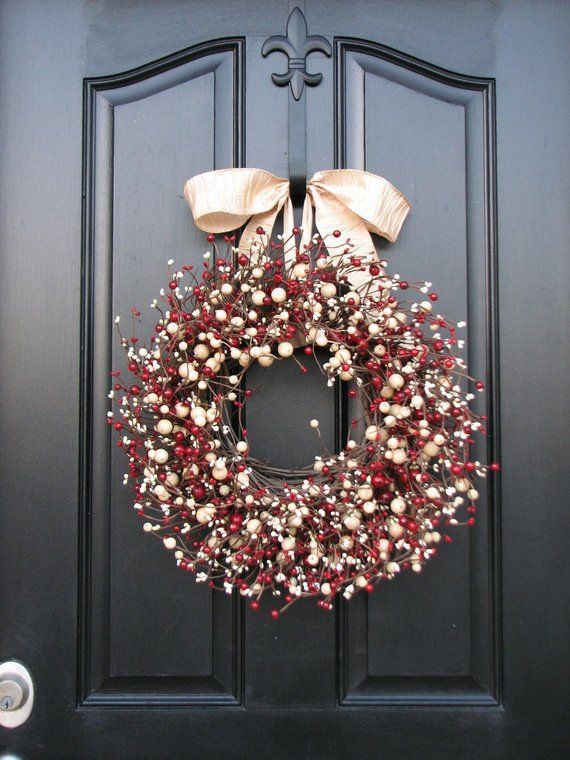 Elegant wreath featuring a blend of red and white frosted berries on a subtle vine base.