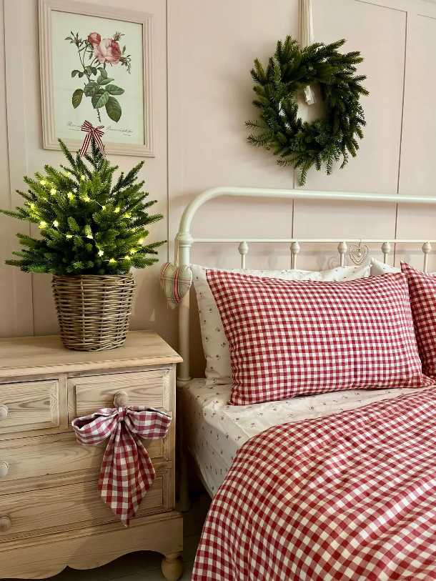 Bedroom with red white plaid bed, mini tree, and simple festive decor.