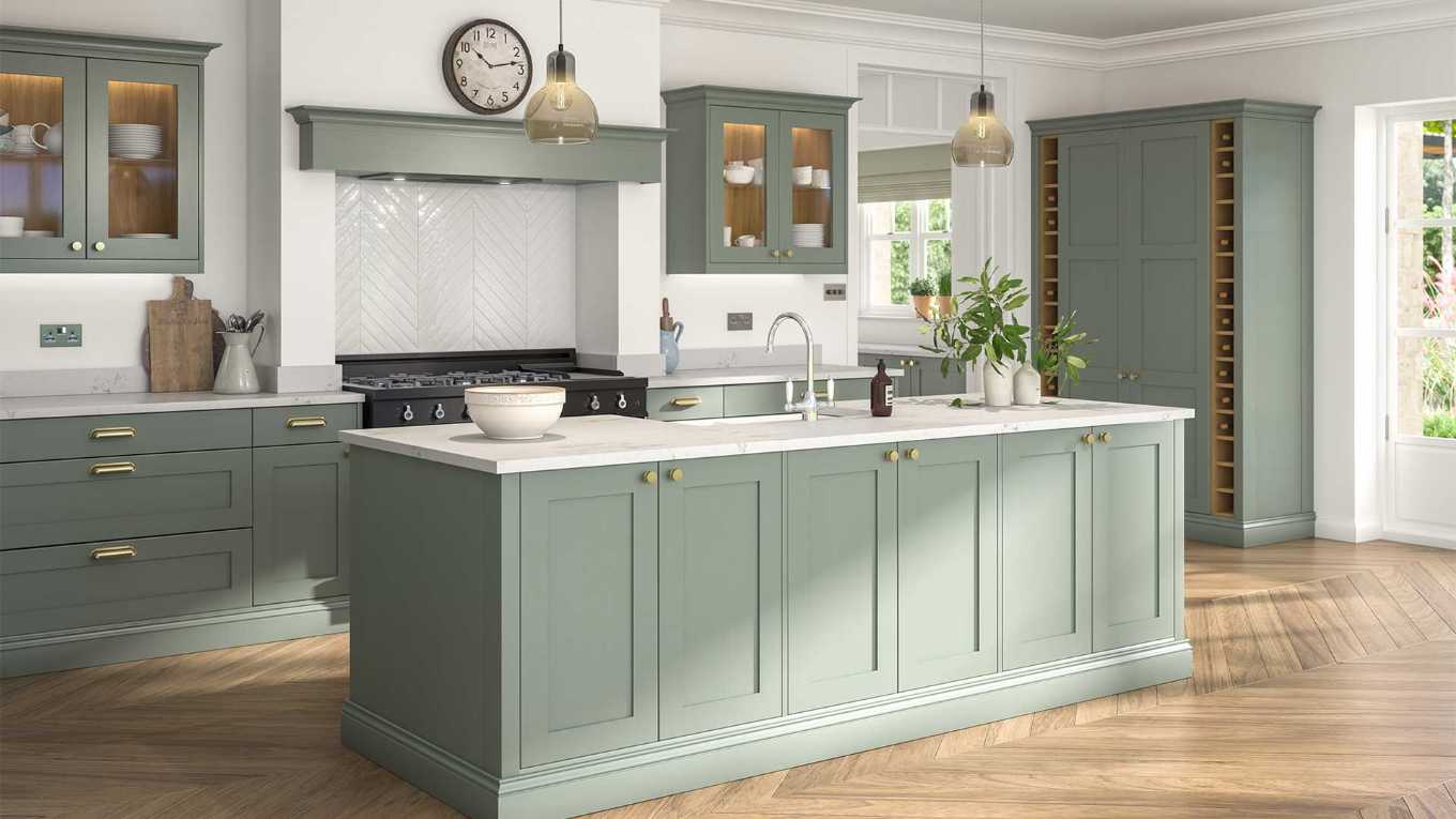 Kitchen with reed green shaker cabinets, white quartz countertop, matte black faucet, natural pine flooring.