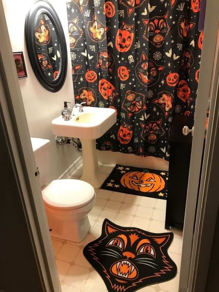 Retro bathroom, black cat and pumpkin face shower curtain, shag rug, teal tiles, warm incandescent lighting.