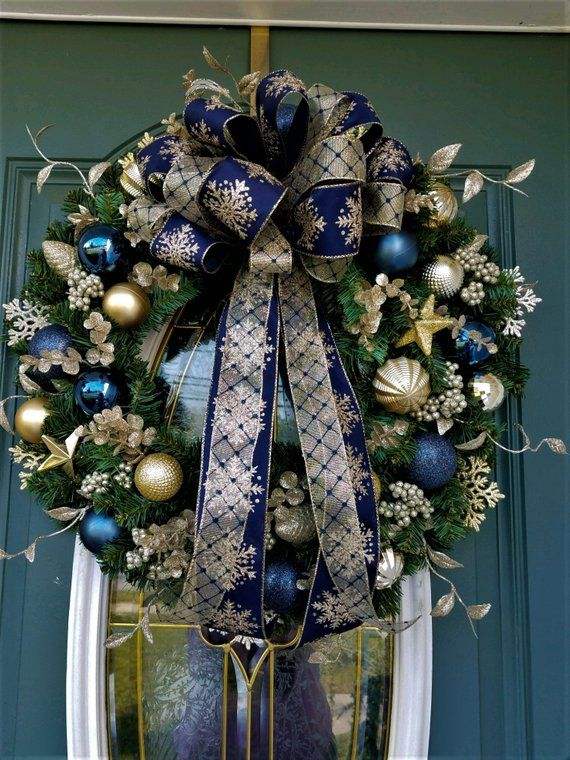 A sophisticated wreath featuring navy blue ribbons and gold metallic accents for a luxury look.