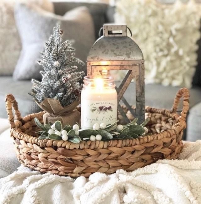 Cozy Christmas coffee table tray arrangement filled with mini pine trees, candles, and rustic pinecones.