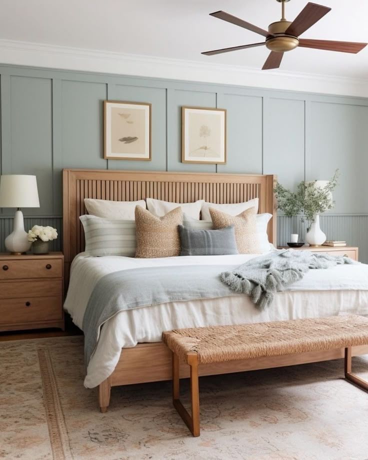 Sage green board and batten walls with a natural wood bed frame