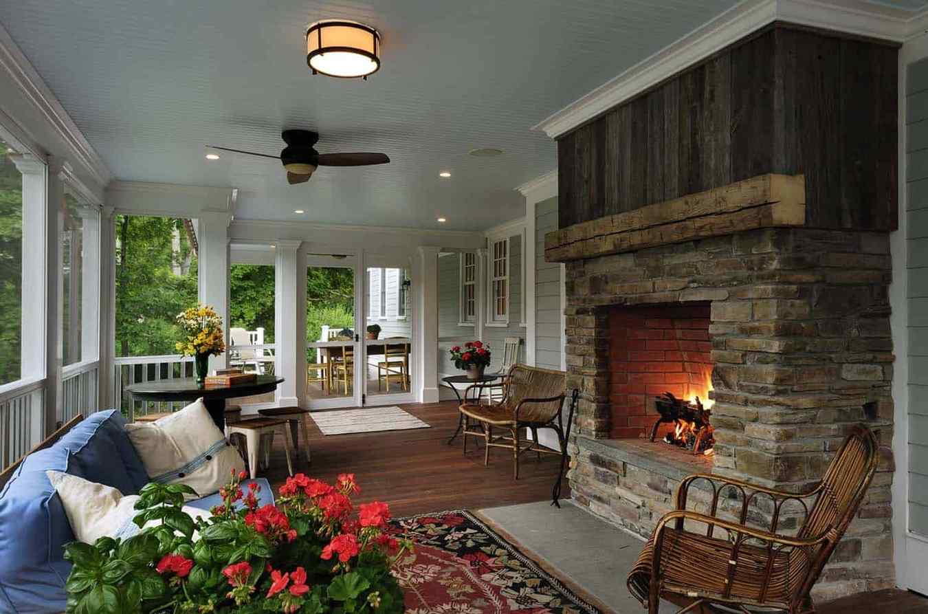 Screened in porch featuring a large daybed positioned in front of windows, airy curtains.