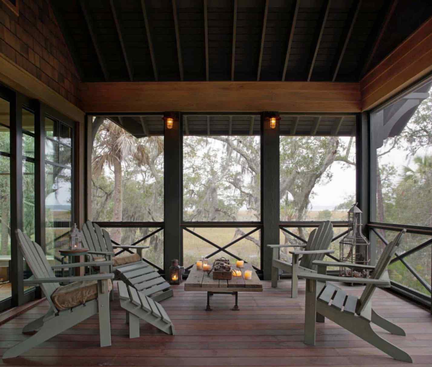 Screened in porch with a long sofa, ceiling fan, and narrow layout furniture arrangement.
