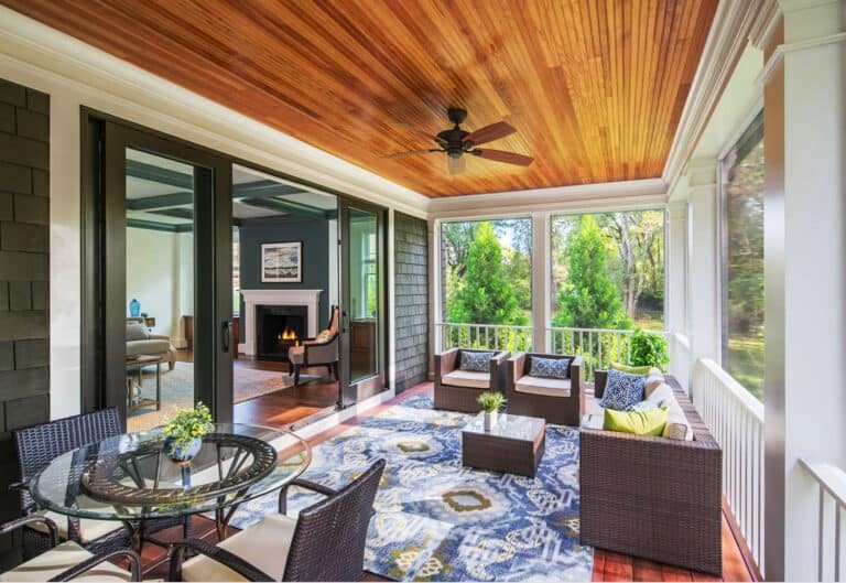 Screened in porch with a built-in grill, countertops, and dining space.