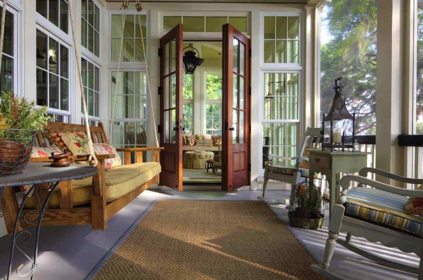 Screened in porch ideas porch swing french doors featuring elegant transitions and cozy seating.
