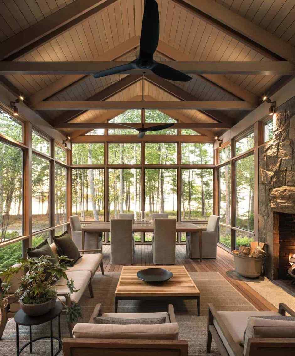 Screened in porch ideas vaulted beams dining fireplace featuring architectural height and elegance.