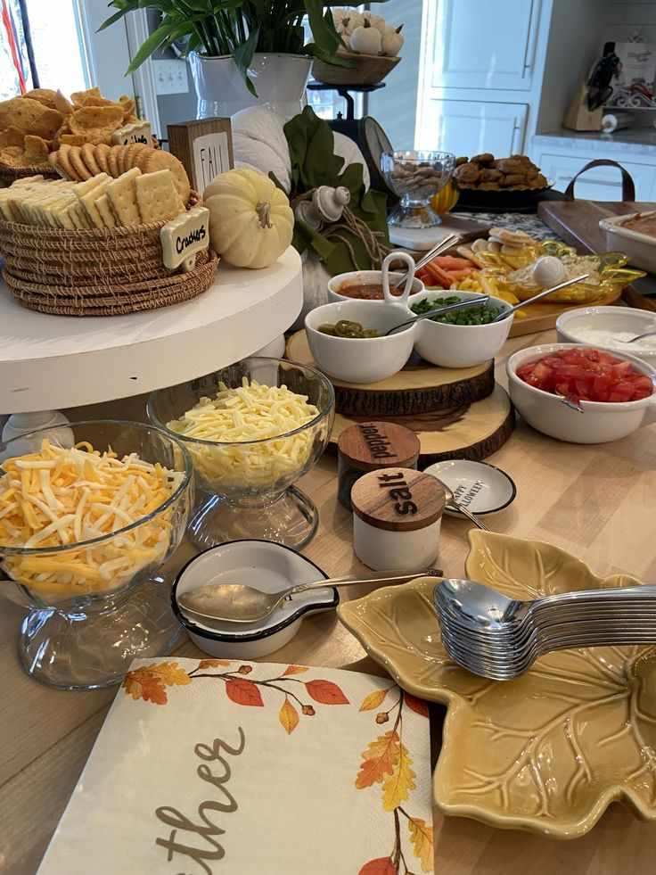 Chili bar with multiple bowls, toppings, wooden serving trays, warm lighting, casual dining setup