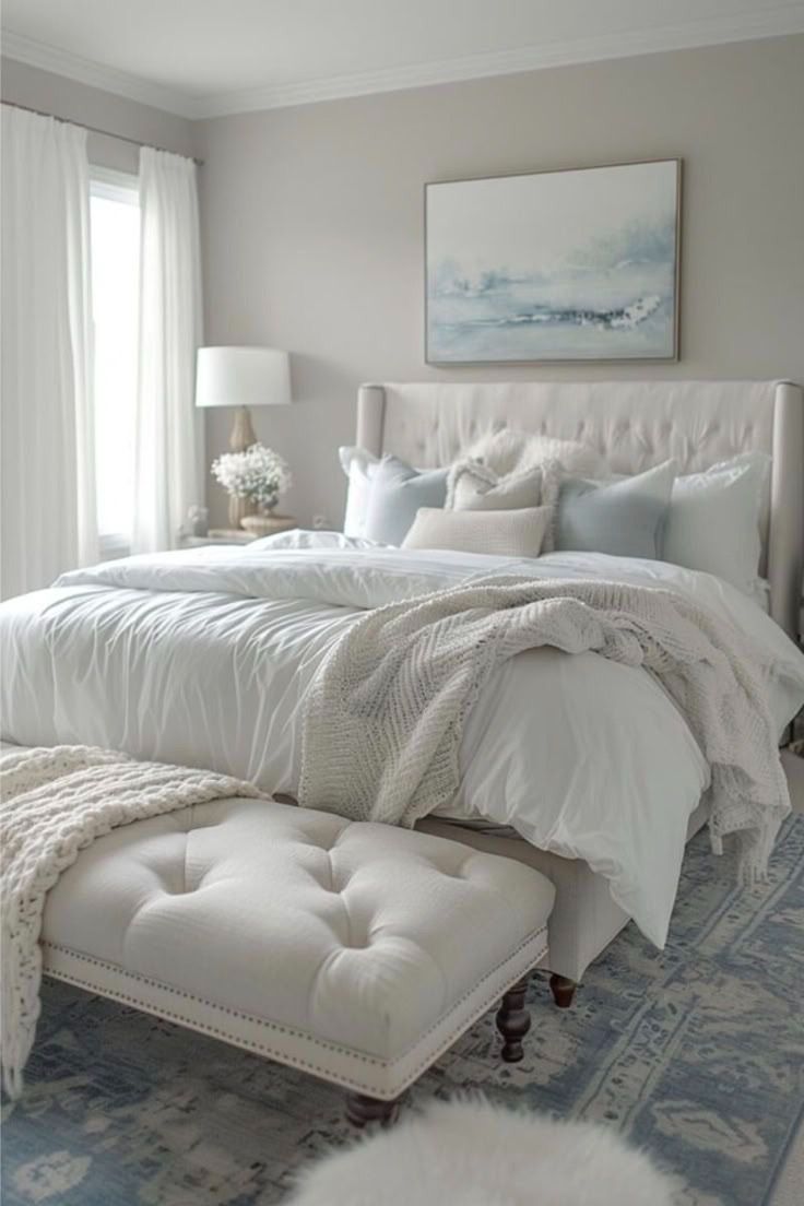 Serene coastal bedroom with a tufted bench and soft blue accents