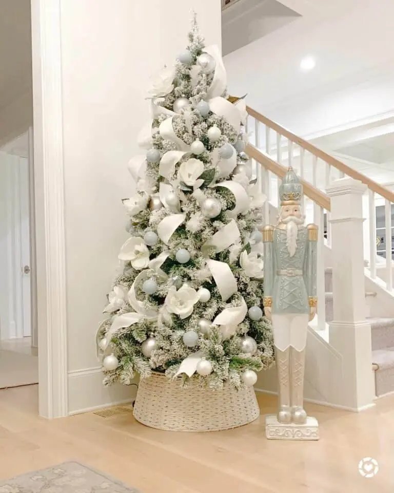 Elegant dining room with frosted silver ribbon tree near travertine table under crystal chandelier
