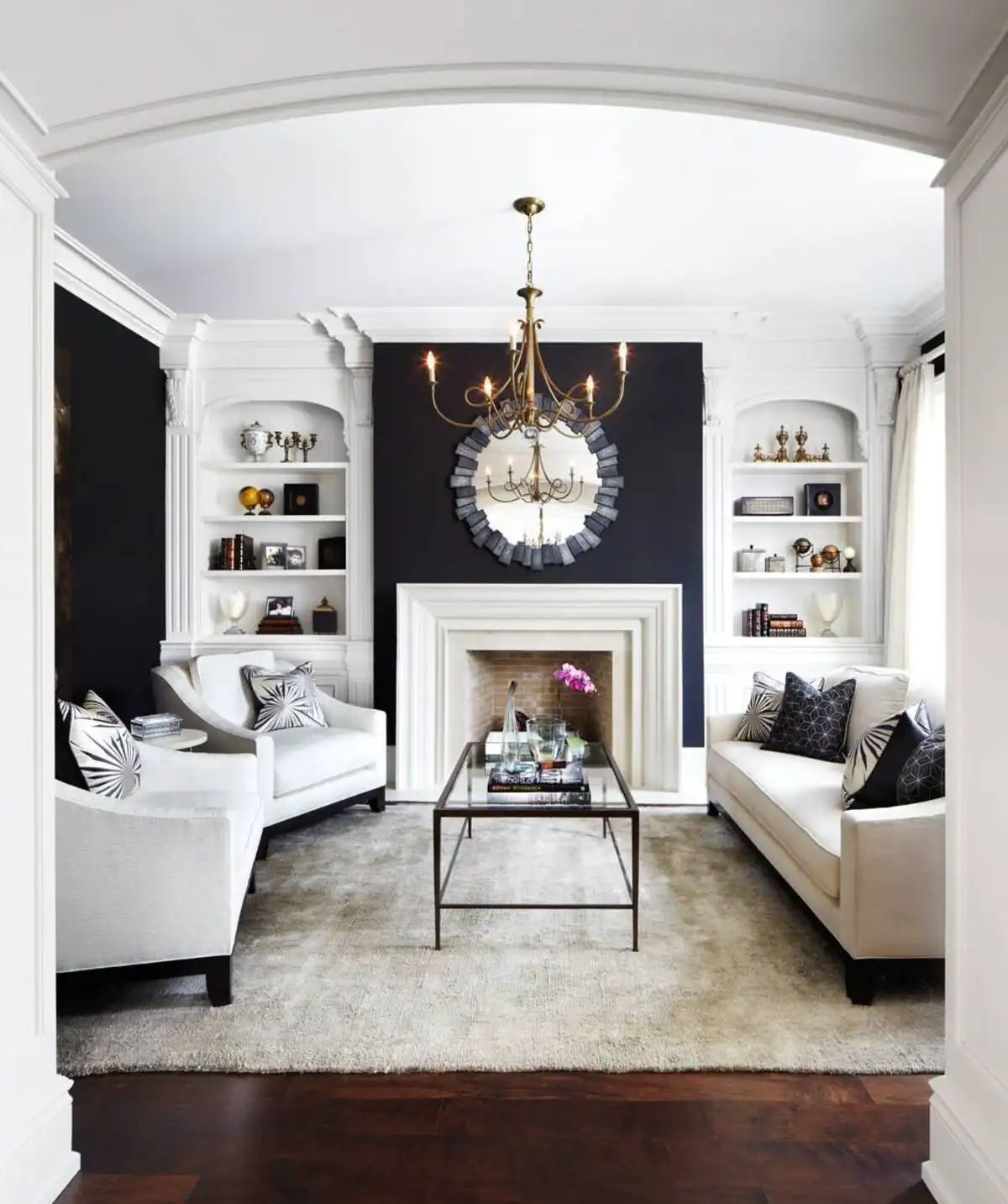 Small luxury living room with black accent wall, white fireplace, and white leather sofa in dramatic lighting.