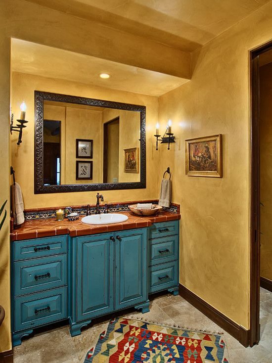 Modern southwestern bathroom with microcement cream walls, matte black fixtures, floating oak vanity, warm lighting.