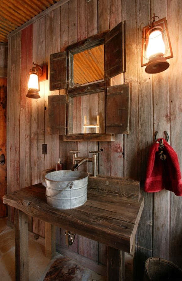 Southwestern style bathroom with saltillo floor tiles arched terracotta alcove forged iron lights and warm vanity