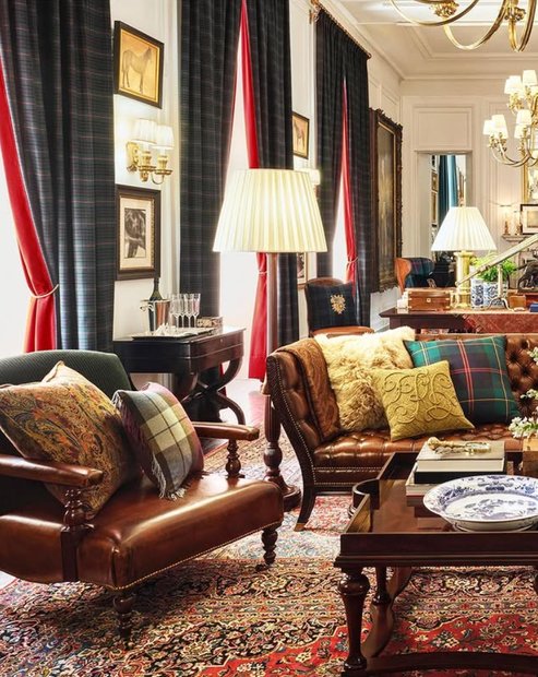 Bedroom with tartan duvet cover, velvet throw, brass bedside lamp, muted lighting.