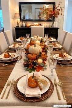 Formal dining room with white pumpkin centerpiece, crystal vase, ivory linens, soft chandelier light