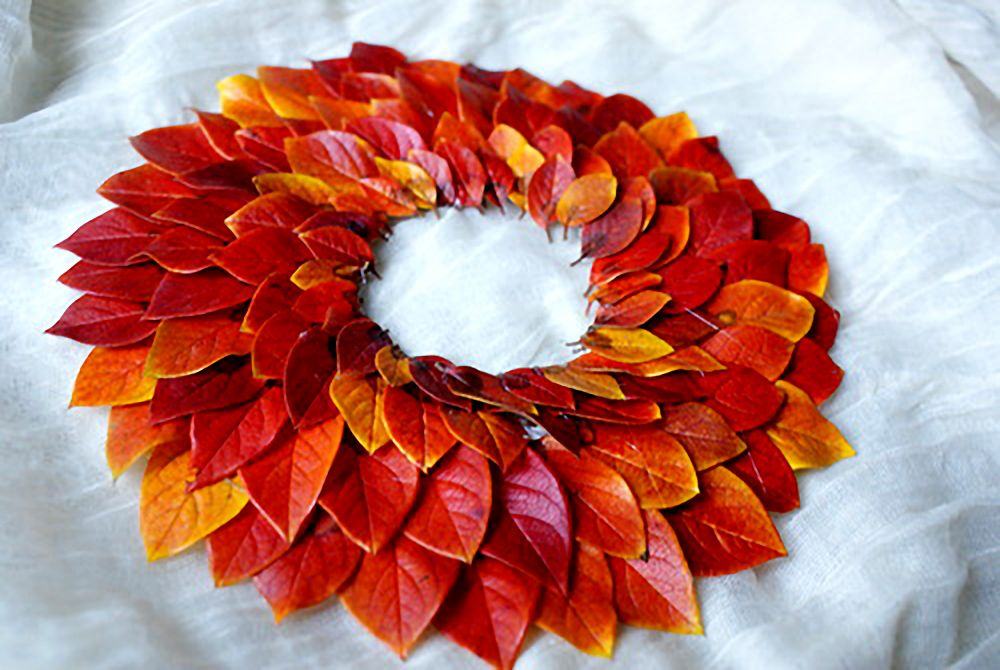 Rustic mantle draped with handmade dried orange slices and golden wheat stalk garlands.