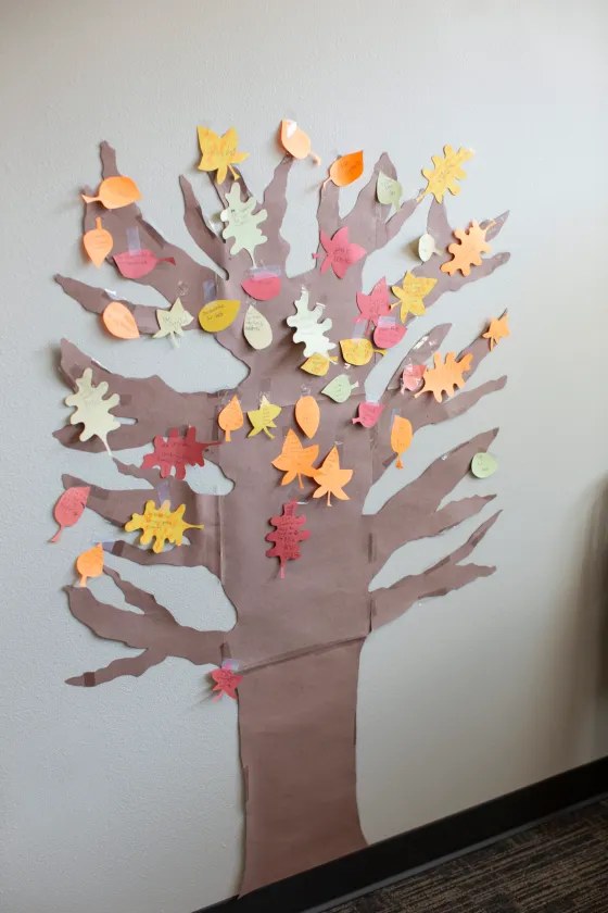 Colorful hand cut felt leaves stitched into a festive runner on dining table.