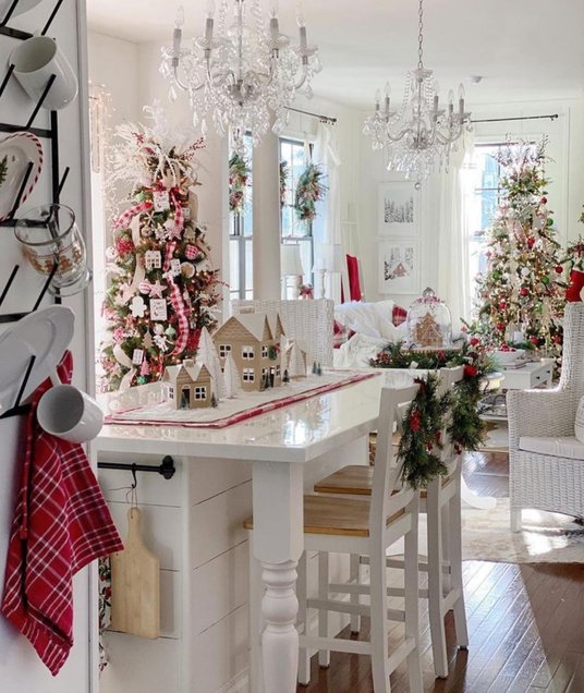 Large tiered tray with holiday treats and greenery on the kitchen island.