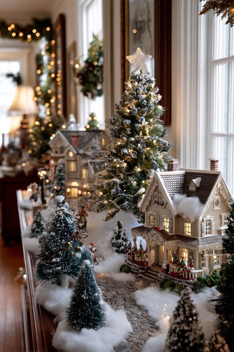 A miniature Christmas village scene on a wooden base on a desk shelf.