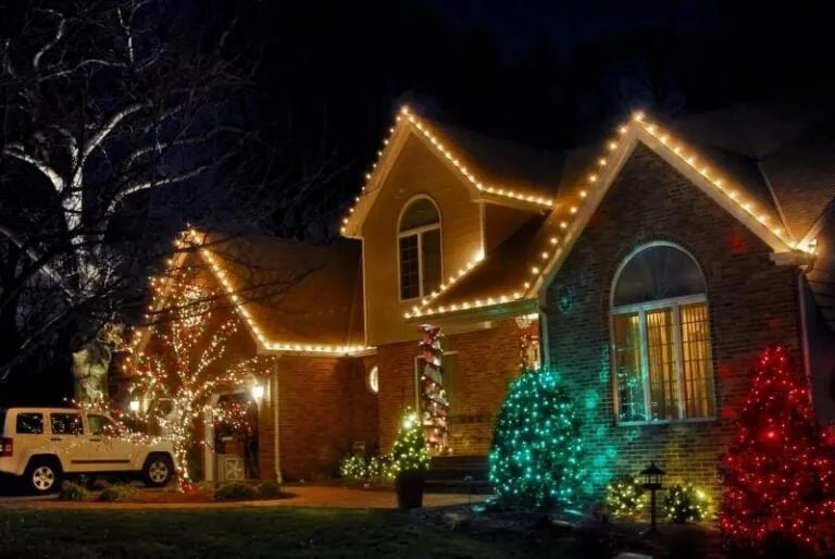 Unevenly spaced christmas lights creating bright spots and dark gaps along a staircase banister.