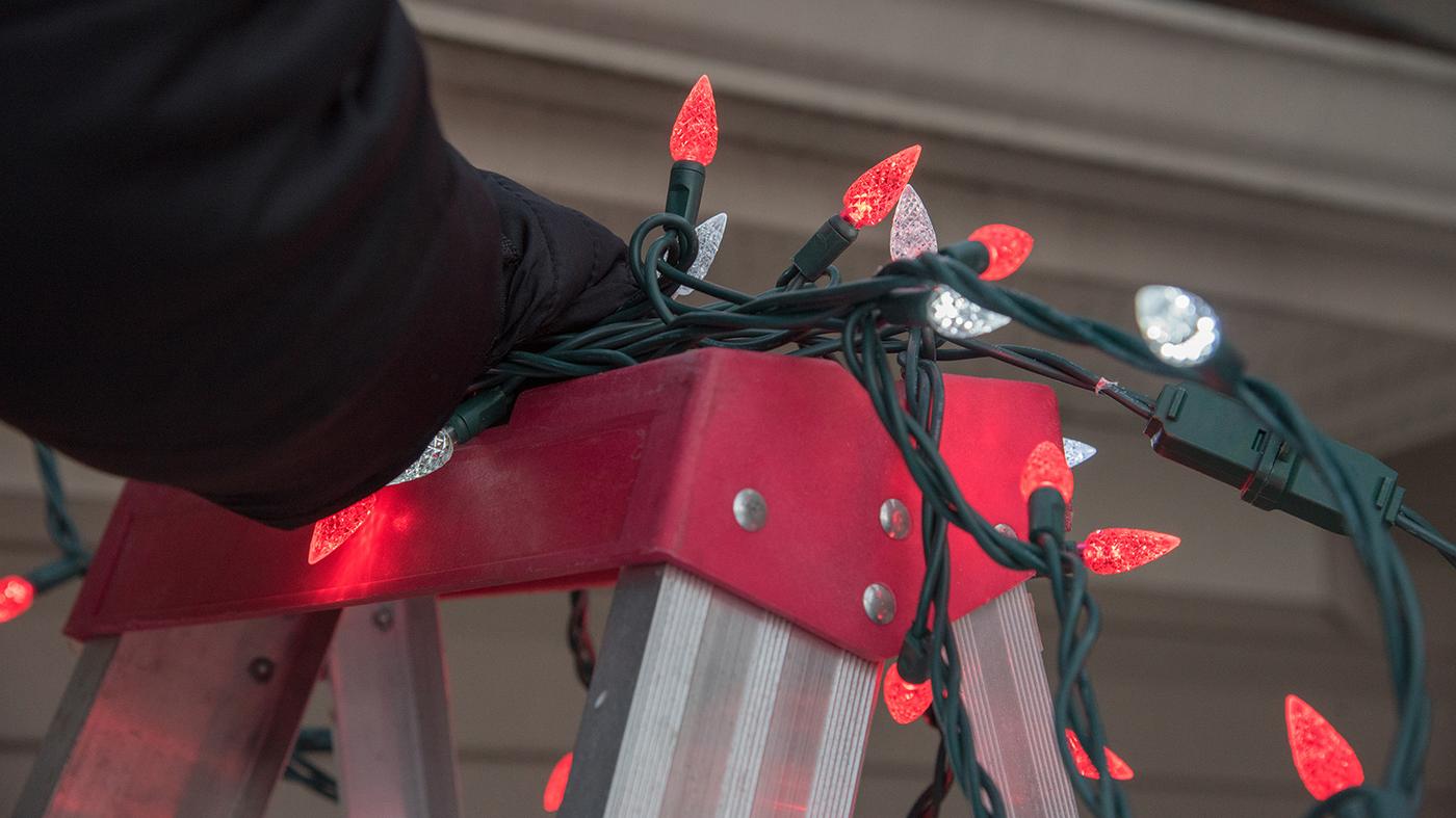 Rapidly strobing multicolor christmas lights creating uncomfortable glaring reflections in a quiet living room.